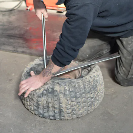 Mechanic working with tyre in Trident Tyres